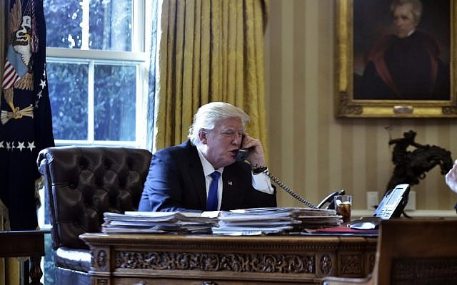 US President Donald Trump speaks on the phone with Russia's President Vladimir Putin from the Oval Office of the White House in Washington, DC on January 28, 2017. (AFP/Mandel Ngan)