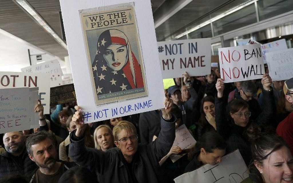 Demonstrators hold signs during a rally against a ban on Muslim immigration at San Francisco International Airport on January 28, 2017 in San Francisco, California. ( Stephen Lam/Getty Images/AFP)