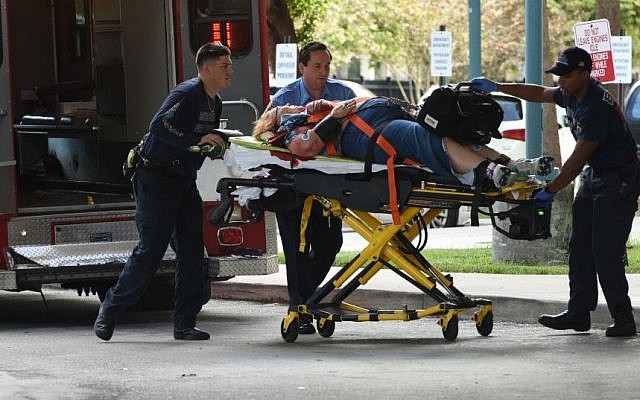 An injured woman is taken into Broward Health Trauma Center in Fort Lauderdale, Fla., after a shooting at the Fort Lauderdale-Hollywood International Airport on Friday, Jan. 6, 2017. (Taimy Alvarez/South Florida Sun-Sentinel via AP)