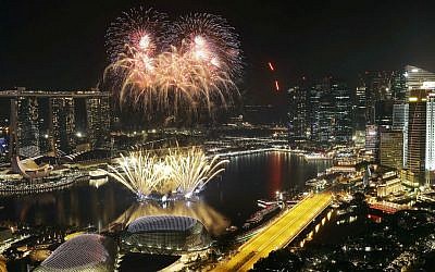Fireworks explode above Singapore's financial district at the stroke of midnight to mark the New Year's celebrations on Sunday, Jan. 1, 2017, in Singapore. (AP Photo/Wong Maye-E)