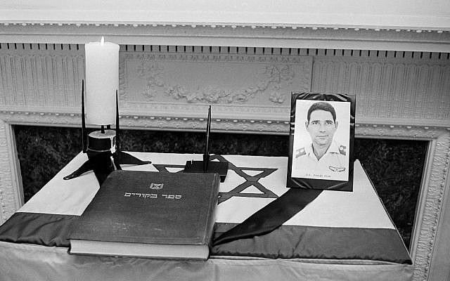 A photo of Israeli Col. Yosef Alon and a visitors book sit on a flag-draped memorial table at the Israeli embassy in Washington, July 1, 1973.  (AP Photo/stf)