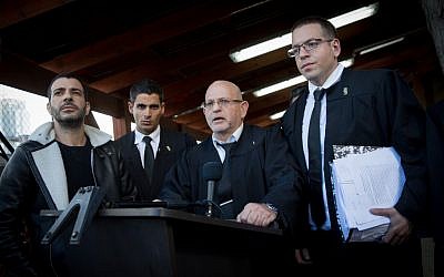 Attorneys Ilan Katz, center, and Eyal Besserglick, right, the legal team of IDF Sgt. Elor Azaria speak to press at the Kirya military base in Tel Aviv following a verdict on January 4, 2017. (Miriam Alster/FLASH90)
