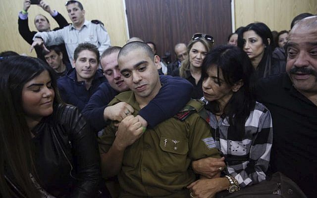 IDF Sgt. Elor Azaria, the Israeli soldier, who shot a Palestinian attacker in Hebron surrounded by family and supports as he arrives to hear his verdict in a courtroom at the Kirya military base, Tel Aviv, January 4, 2017. (Miriam Alster/Flash90) 
