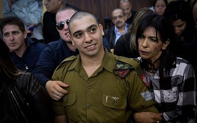 IDF Sgt. Elor Azaria, the Israeli soldier who shot a Palestinian attacker, in Hebron, surrounded by family and supporters as he arrives to hear his verdict in a courtroom at the Kirya military base, Tel Aviv, January 4, 2017. (Miriam Alster/Flash90)