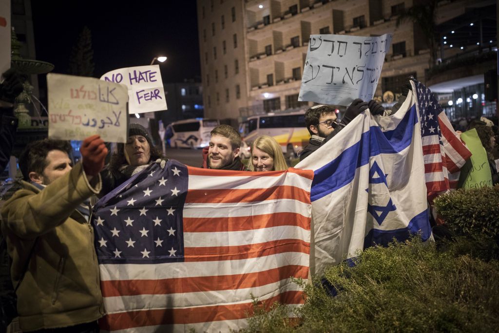 Protesters holding placards during near the Prime minister residence in Jerusalem against Trump’s recent anti-refugee and anti-migrant Executive Orders, January 29, 2017. (Yonatan Sindel/Flash90)