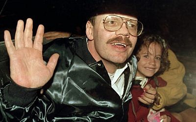 In this Dec. 4, 1991, file photo Terry Anderson, who was the longest held American hostage in Lebanon, grins with his 6-year-old daughter Sulome as they leave the US Ambassador's residence in Damascus after Anderson's release. (AP Photo/Santiago Lyon, File)