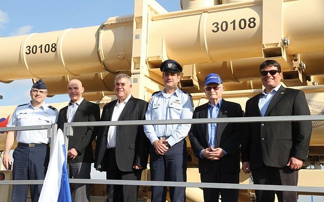 From right, Moshe Patel, head of the Defense Ministry's missile program, David Ivri, president of Boeing-Israel, Brig. Gen. Tzvika Haimovitch, head of the army's Aerial Defense Command, Boaz Levi, vice president of IAI's missile division, Danny Gold, the former head of the ministry's missile program, and Brig. Gen. William Cooley, of the US Air Force, stand in front of a Arrow 3 missile defense system that was delivered to the Israeli Air Force on January 18, 2017. (Defense Ministry)