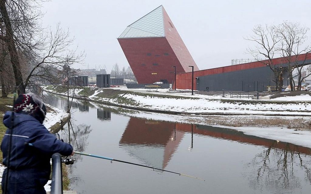 A woman fishes near the Museum of the Second World War, an ambitious new museum under creation for nine years which is almost completed, in Gdansk, Poland, on Monday, January 23, 2017. (AP Photo/Czarek Sokolowski)