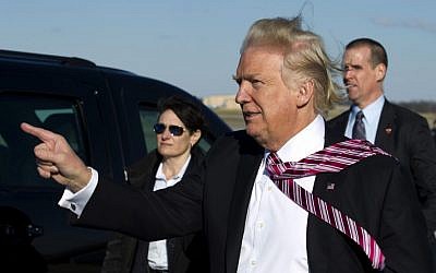 President Donald Trump points to guests upon his arrival at Andrews Air Force One, Md., Thursday, Jan. 26, 2017. Trump is returning from Philadelphia after speaking at the House and Senate GOP lawmakers at their annual policy retreat. ( AP/Jose Luis Magana)