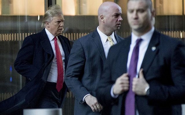 President-elect Donald Trump, left, departs a meeting at the Condé Nast offices at One World Trade Center in New York, Friday, Jan. 6, 2017. (AP Photo/Andrew Harnik)
