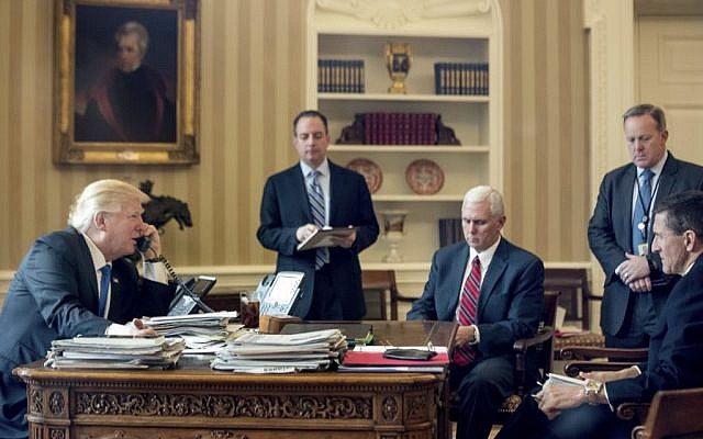 President Donald Trump, with Chief of Staff Reince Priebus, Vice President Mike Pence, White House press secretary Sean Spicer and National Security Adviser Michael Flynn, speaks on the phone with with Russian President Vladimir Putin, Saturday, Jan. 28, 2017, in the Oval Office at the White House in Washington. (AP Photo/Andrew Harnik)