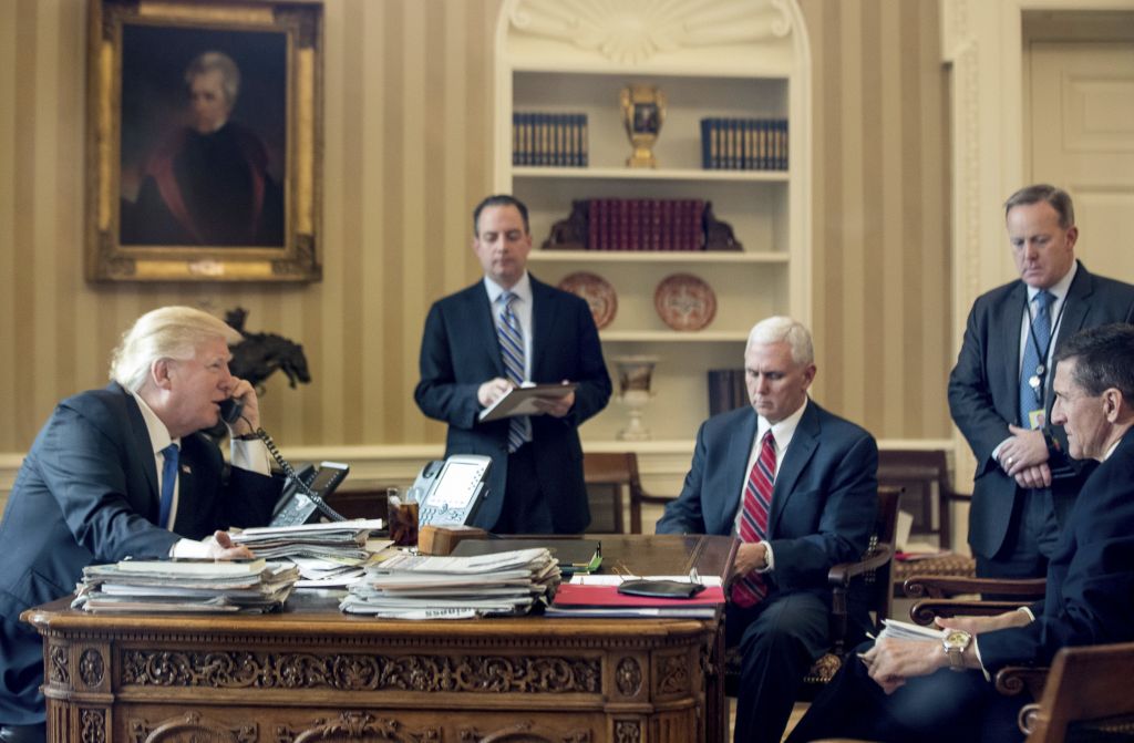 President Donald Trump, with Chief of Staff Reince Priebus, Vice President Mike Pence, White House press secretary Sean Spicer and National Security Adviser Michael Flynn, speaks on the phone with with Russian President Vladimir Putin, Saturday, Jan. 28, 2017, in the Oval Office at the White House in Washington. (AP Photo/Andrew Harnik)