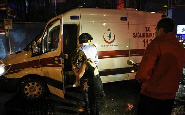People talk to medics in an ambulance near the scene of an apparent terror attack in Istanbul, early Sunday, Jan. 1, 2017. (AP Photo)