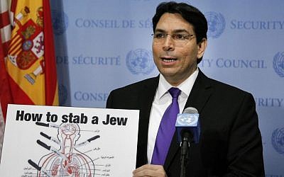 Illustrative: Israel's UN ambassador Danny Danon teaches reporters how to stab a Jew, with a teaching aid commonly found in Palestinian schools. (Loey Felipe)