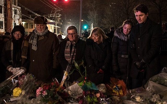 (L-R) Philippe Couillard's wife, Quebec prime minister Philippe Couillard, Quebec city mayor Regis Labeaume, his wife, Sophie Gregoire (Justin Trudeau's wife) and  Canadian prime minister Justin Trudeau lay flowers near the Islamic Cultural Center in Quebec City, Canada on January 30, 2017. (AFP Photo/Alice Chiche)