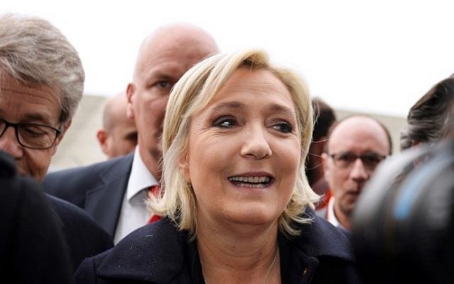 Head of the far-right party FN and presidential candidate Marine Le Pen (C) smiles as she arrives to visit the Salon des Entrepreneurs (Entrepreneurship fair) in Paris on February 1, 2017. (AFP/Eric Piermont)