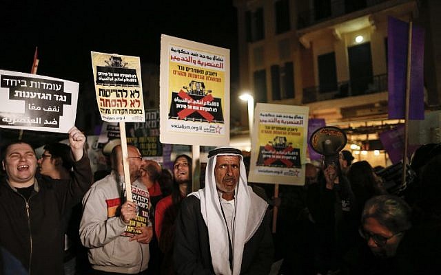 Arabs and Jews participate in a demonstration against Prime Minister Benjamin Netanyahu and against the home demolition policy, in Tel Aviv on February 4, 2017. (AFP PHOTO/AHMAD GHARABLI)