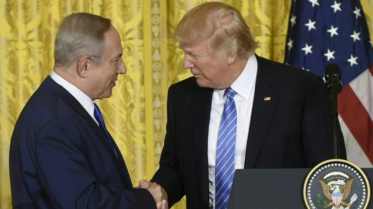 US President Donald Trump and Israeli Prime Minister Benjamin Netanyahu shake hands during a joint press conference at the White House in Washington, DC on February 15, 2017, where both leaders refused to commit to the two-state model as a solution to the Israeli-Palestinian conflict. (Saul Loeb/AFP)
