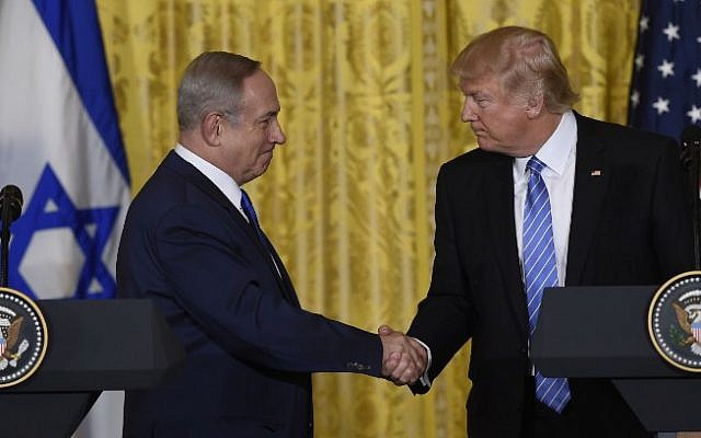 US President Donald Trump and Prime Minister Benjamin Netanyahu shake hands during a joint press conference in the East Room of the White House in Washington, DC, February 15, 2017. (AFP PHOTO / SAUL LOEB)