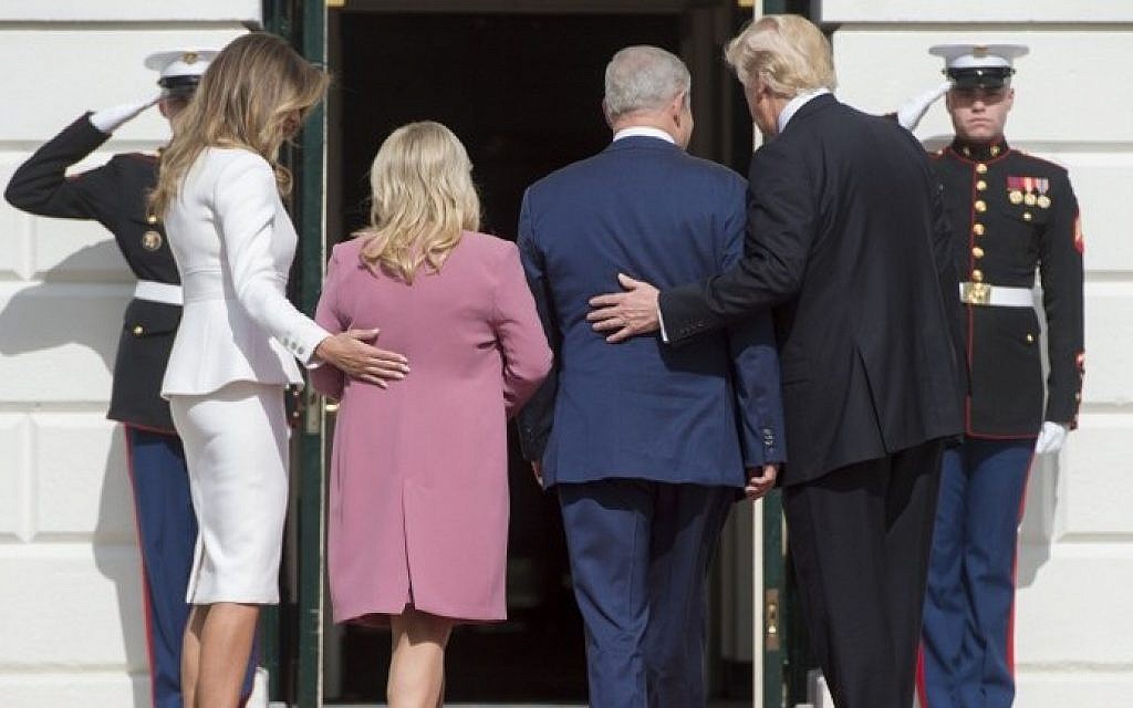 US President Donald Trump, right, and First Lady Melania Trump, left, greet Israeli Prime Minister Benjamin Netanyahu and his wife, Sara, as they arrive at the White House in Washington, DC, February 15, 2017. AFP/SAUL LOEB)