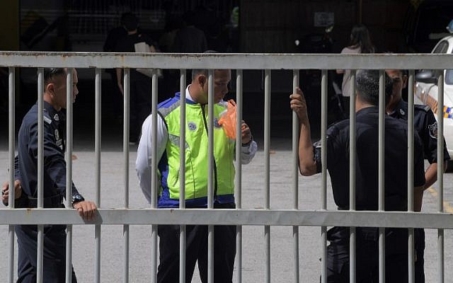 Members of the Royal Malaysian Police man the main gate of the forensics wing of the Hospital Kuala Lumpur in Kuala Lumpur on February 18, 2017, where the body of a North Korean man suspected to be Kim Jong-Nam, half-brother of a North Korean leader Kim Jong-Un, is being kept. (AFP PHOTO/MOHD RASFAN)