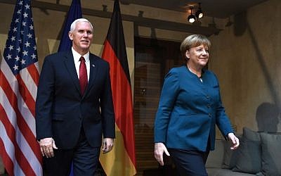 US Vice President Mike Pence (L) and German Chancellor Angela Merkel leave the room after a photo call prior to a bilateral meeting on the 2nd day of the 53rd Munich Security Conference (MSC) at the Bayerischer Hof hotel in Munich, southern Germany, on February 18, 2017. (AFP PHOTO / Christof STACHE)