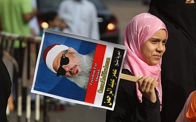 An Egyptian girl holds a portrait of cleric Sheikh Omar Abdel Rahman during a sit-in to call for his release in front of the US Embassy in Cairo on August 30, 2011. (AFP PHOTO/KHALED DESOUKI)