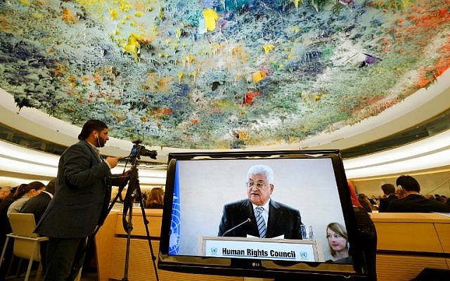 Palestinian Authority President Mahmud Abbas is seen on a TV screen while speaking during a meeting of the United Nations Human Rights Council on February 27, 2017 in Geneva, Switzerland (AFP/Fabrice Coffrini)