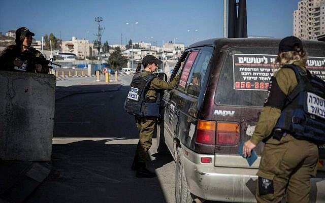 Illustrative photo of female Military Police officers checking the IDs and vehicles of Palestinians at the checkpoint at the Shuafat Refugee Camp in East Jerusalem, on December 22, 2015. (Hadas Parush/Flash90)