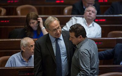 Prime Minister Benjamin Netanyahu and Joint (Arab) List chairman Aiman Odeh talk during a vote on the Regulation Bill in the Knesset on December 7, 2016. (Hadas Parush/Flash90)