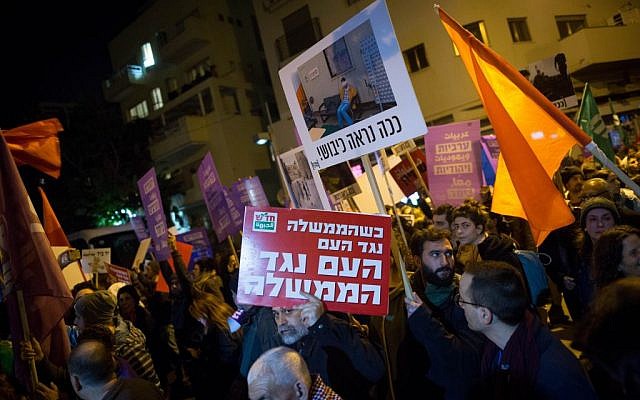 Thousands of Jews and Arabs attend a protest against the treatment of the Arab community, in Tel Aviv on February 4, 2017. The red banner reads: 'When the government is against the nation, the nation is against the government.' (Photo by Miriam Alster/FLASH90)
