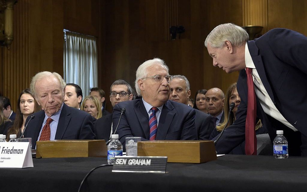 In this Wednesday, Feb. 15, 2017 photo, Sen. Lindsey Graham, R-SC, right, talks with David Friedman, center, nominated to be US ambassador to Israel, accompanied by former Connecticut Sen. Joseph Lieberman on Capitol Hill in Washington, during Friedman's confirmation hearing before the Senate Foreign Relations Committee. (AP Photo/Susan Walsh)