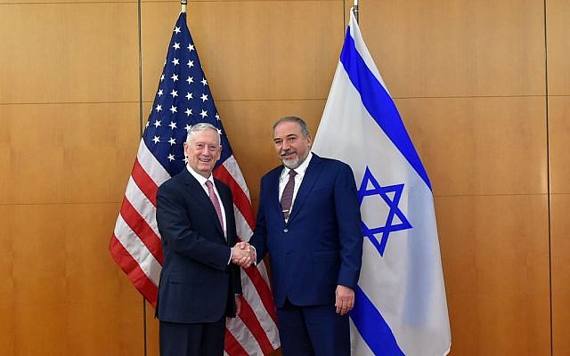 Defense Minister Avigdor Liberman shakes hands with US Secretary of Defense James Mattis at the Munich Security Conference on February 17, 2017. (Ariel Hermoni/Defense Ministry)