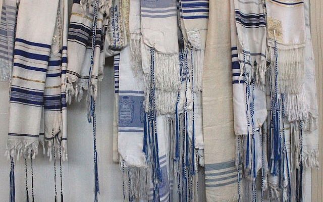 A rack of prayer shawls at Congregation B’nai Israel shows the unique style of tzitzit used by Karaite Jews. (David A.M. Wilensky)