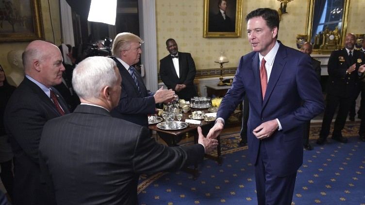 This file photo taken on January 22, 2017 shows  US Vice President Mike Pence, 2nd left, shaking hands with FBI Director James Comey, right, watched by Secret Service Director Joseph Clancy, left, and US President Donald Trump, 3rd right, during the reception for law enforcement officers and first responders in the Blue Room of the White House in Washington, DC. (AFP/ MANDEL NGAN)