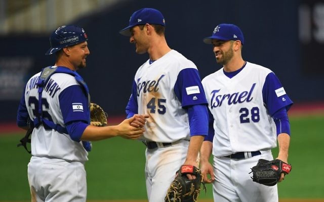 This file photo taken on March 9, 2017 shows Catcher Ryan Lavarnway (L) of Israel celebrating their victory with teammates pitcher Josh Zeid (R) and infielder Nate Freiman (C) against the Netherlands after their first round game of the World Baseball Classic at Gocheok Sky Dome in Seoul. (AFP PHOTO / JUNG Yeon-Je)