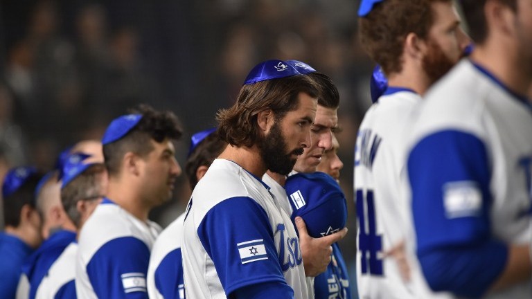 Israel's pitcher Joey Wagman (C) and his teammates sing the national anthem prior to the team's second round match against The Netherlands in Tokyo on March 13, 2017. (AFP Photo/Kazuhiro Nogi)
