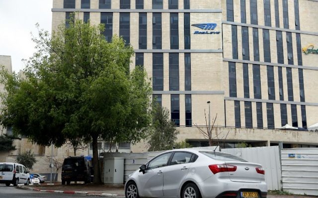 A car drives past the offices of Israeli car tech firm Mobileye in Jerusalem on March 13, 2017.
Intel will buy Mobileye for more than $15 billion (14 billion euros), the companies said. (AFP/Thomas Coex)