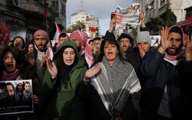 Palestinian demonstrators march in the West Bank city of Ramallah against the security coordination between PA security forces and Israel on March 13, 2017. (AFP Photo/Abbas Momani)