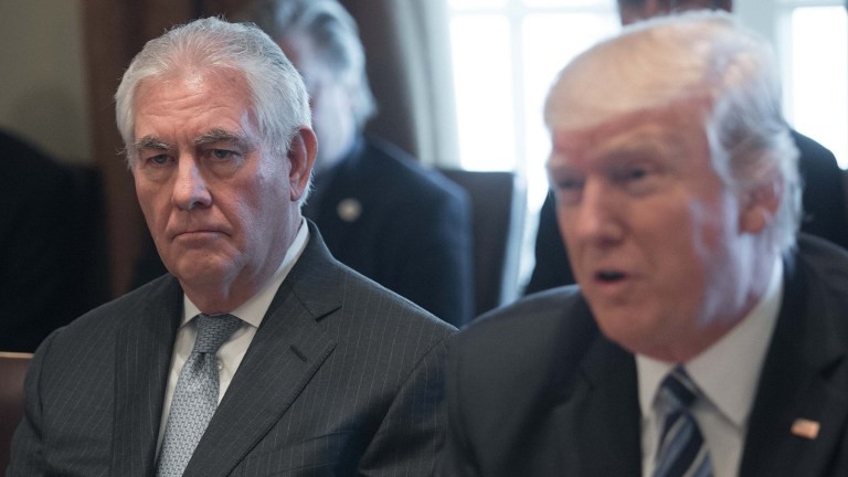 US Secretary of State Rex Tillerson (L) looks on as US President Donald Trump speaks to the press before he meets with his cabinet in the Cabinet Room at the White House on March 13, 2017. (AFP Photo/Nicholas Kamm)