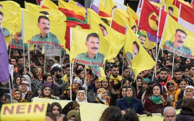 Kurdish protesters demonstrate with placards reading "No to dictatorship" and the portrait of the leader of the Kurdistan PKK Workers' Party, Abdullah Ocalan in the city center of Frankfurt am Main, western Germany, on March 18, 2017. (AFP Photo/dpa/Boris Roessler)