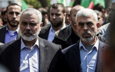 Yahya Sinwar (R) the new leader of Hamas in the Gaza Strip and senior Hamas official Ismail Haniyeh attend the funeral of Hamas official Mazen Faqha in Gaza city on March 25, 2017. (AFP Photo/Mahmud Hams)
