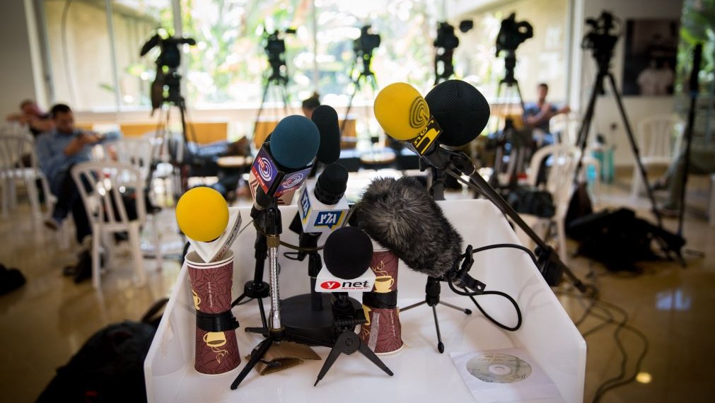 Microphones and video cameras of Israeli media outlets set up for press conference. (Miriam Alster/Flash90)