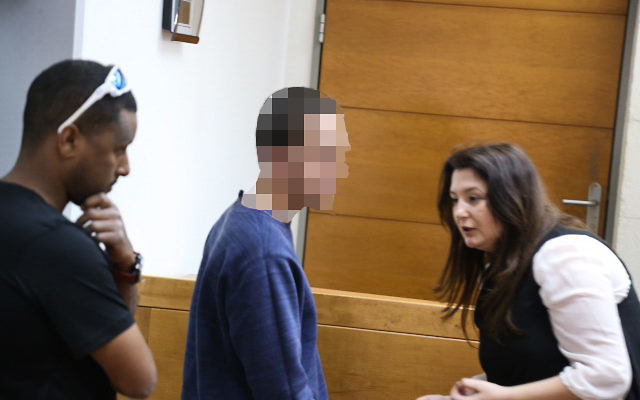 A Jewish Israeli teen is brought for a court hearing at the Rishon Lezion Magistrate's Court, on suspicion of issuing fake bomb threats against Jewish institutions in the US and around the world, on March 23, 2017. (Flash90)