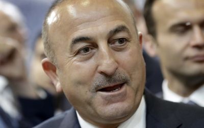 The Foreign Minister of Turkey Mevlut Cavusoglu speaks during a visit of the booth of Turkey at the tourism fair ITB in Berlin, Germany, Wednesday, March 8, 2017. (AP Photo/Michael Sohn)