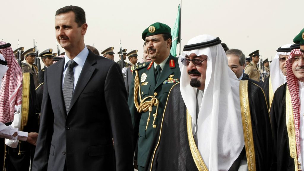 In this March 11, 2009 photo, King Abdullah of Saudi Arabia, right, welcomes Syrian President Bashar Assad upon his arrival in the Saudi capital Riyadh. (AP Photo/Hassan Ammar)