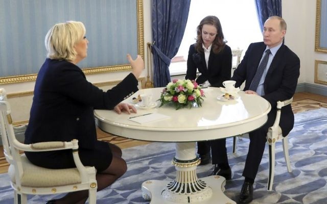 French far-right presidential candidate Marine Le Pen, left, gestures while speaking to Russian President Vladimir Putin, right, during their meeting in the Kremlin in Moscow, Russia, on Friday, March 24, 2017. (Mikhail Klimentyev/Sputnik, Kremlin Pool Photo via AP)