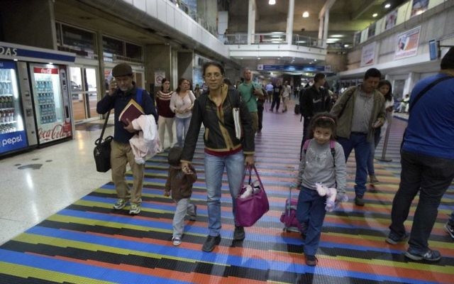 Illustrative: In this March 17, 2017 photo, Jewish converts Sahir Quitero, center, her husband Franklin Perez, son Ezra, left, and daughter Hannah, walk to departures lounge of the Simon Bolivar International Airport in Maiquetia, Venezuela, on their way to Israel. (AP Photo/Fernando Llano)