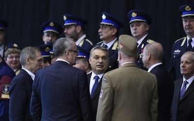 Hungarian Prime Minister Viktor Orban, center, attends a swearing-in-ceremony for a new group of border guards known locally as “border hunters,” in Budapest, Hungary, Tuesday, March 7, 2017. (Szilard Koszticsak/MTI via AP)