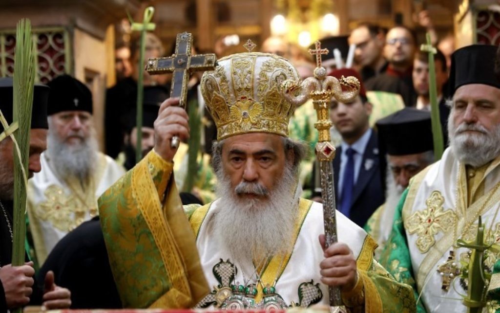 Greek Orthodox Patriarch of Jerusalem Theophilos III (C) leads the Palm Sunday Easter procession at the Church of the Holy Sepulchre in Jerusalem's Old City on April 9, 2017. (AFP Photo/Gali Tibbon)